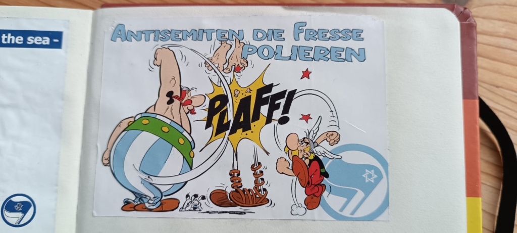 An illustration of the characters Asterix and Obelix punching a Roman skywards out of his sandals. “Polish the antisemites’ faces.”
