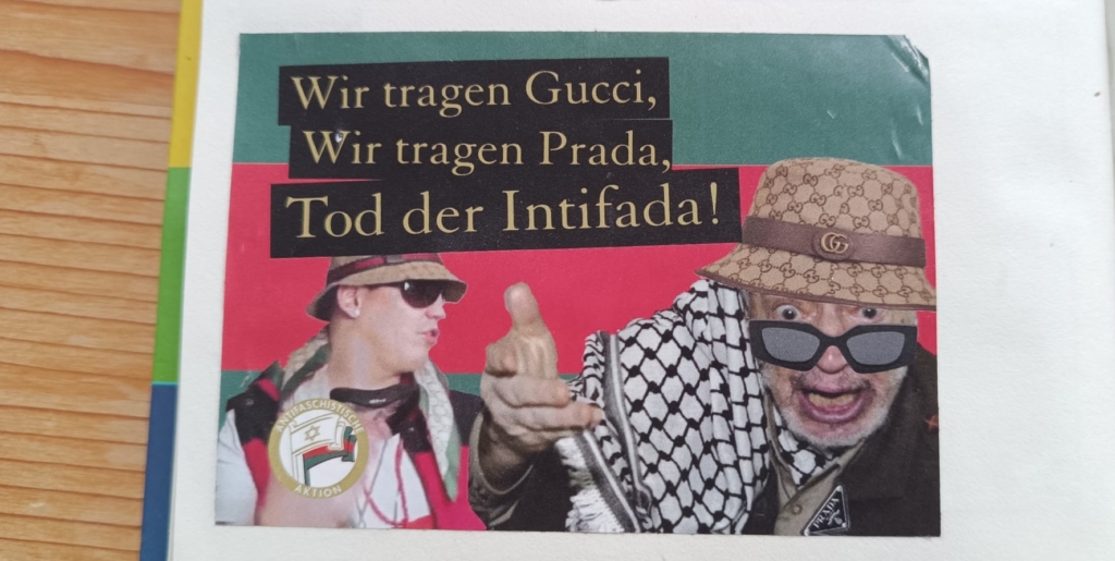 An unflattering photograph of Yasser Arafat, wearing a kaffiyeh, with a Gucci bucket hat sloppily photoshopped onto his head. Behind him and to the viewer’s left is a photograph of Austrian rapper Money Boy. “We wear Gucci, we wear Prada, death to the Intifada!”